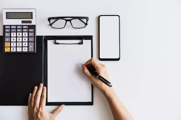 mental health assessor taking notes during an appointment
