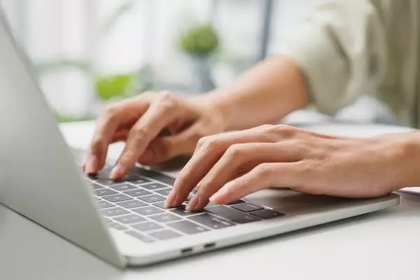  person typing on a laptop
